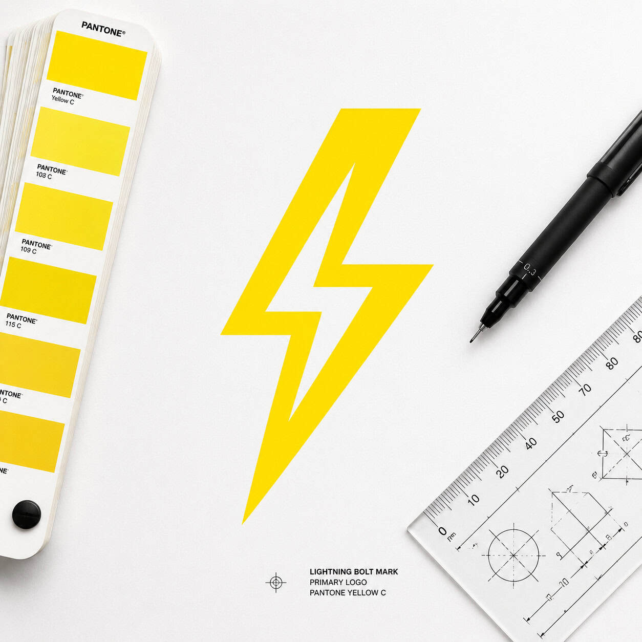 () close-up macro shot of a minimalist logo design process: a single electric yellow lightning bolt symbol on white paper,
